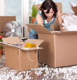 de cluttering a home before moving, woman surrounded by packing boxes