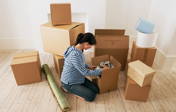 moving preparation, woman sitting on the floor packing boxes