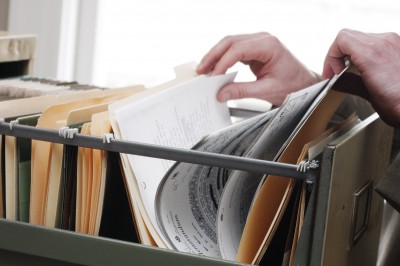 commercial business relocation, person flicking through documents ready to move their business.