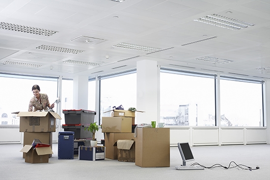 Stacks of boxes in an almost empty office ready for moving