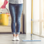 woman holding a bucket and mop